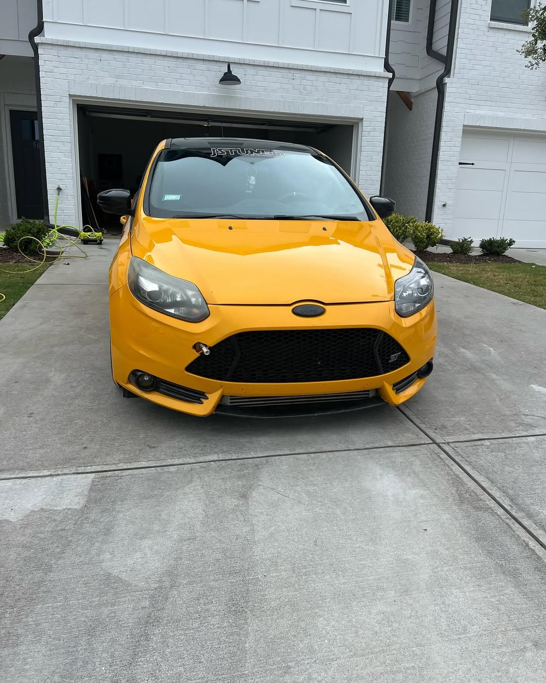 Yellow Ford Focus ST front-end gleaming after detail